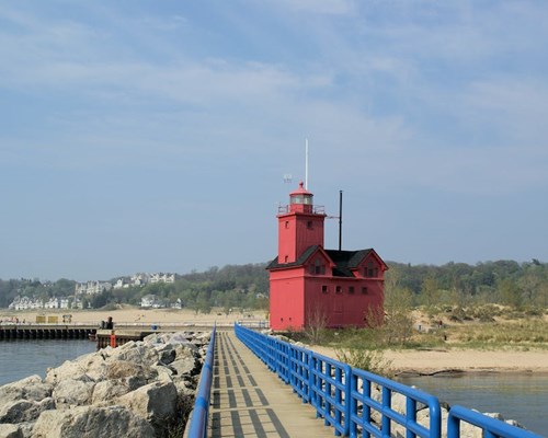 Dock and red lighthouse along lake