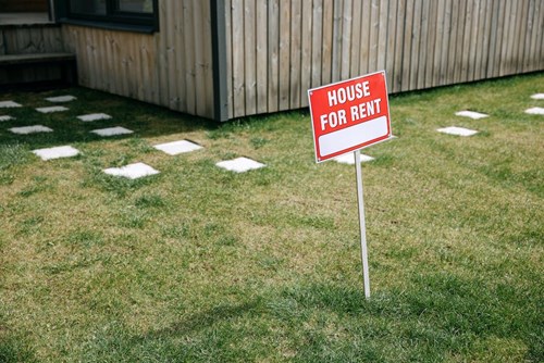 Yard sign reading 'House for rent'
