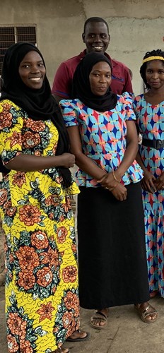 Four smiling Tanzanian teachers. Three women and one man. 
