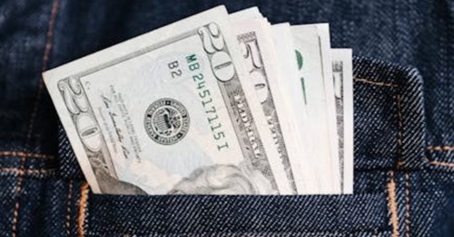 Jena jacket pocket filled with U.S. dollar bills