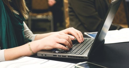 Person typing on computer